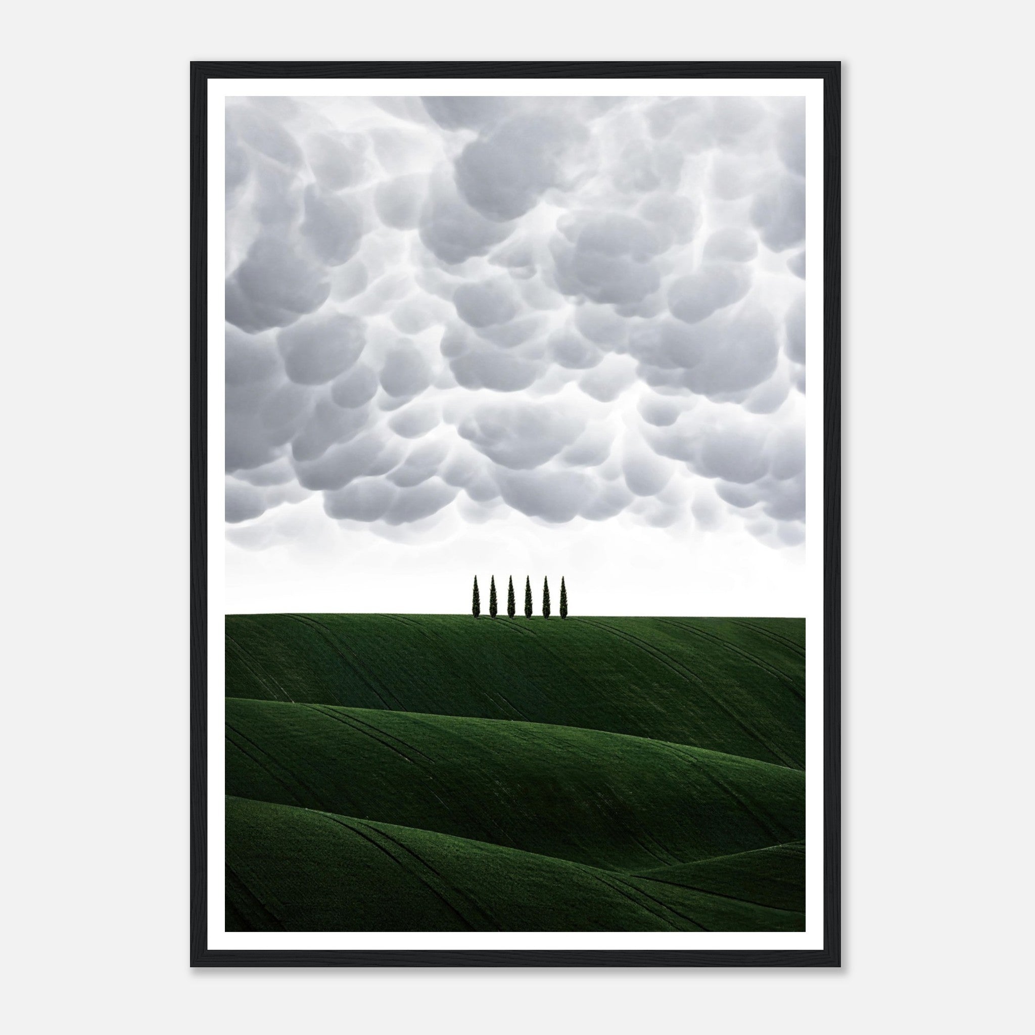 Toscana Italy framed print with rolling green hills and cypress trees under dramatic clouds. Perfect for elegant decor.