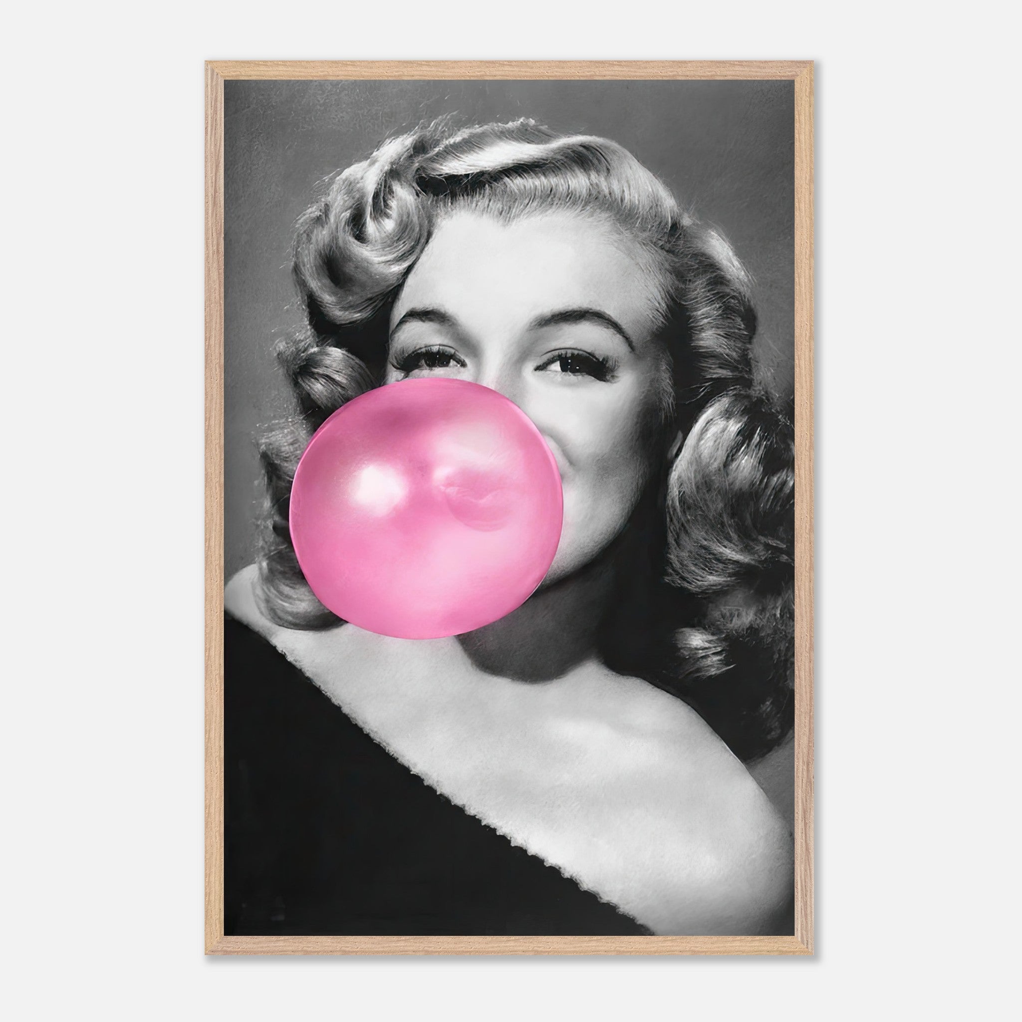 Vintage framed print of Marilyn Monroe blowing a pink bubble gum, exuding sass and glamour for chic wall decor.