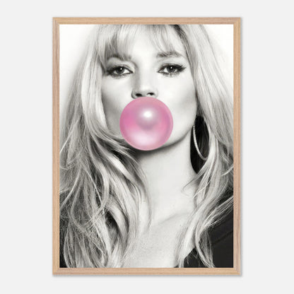 Vintage framed print of Kate Moss blowing pink bubble gum, featuring a stylish black-and-white portrait.