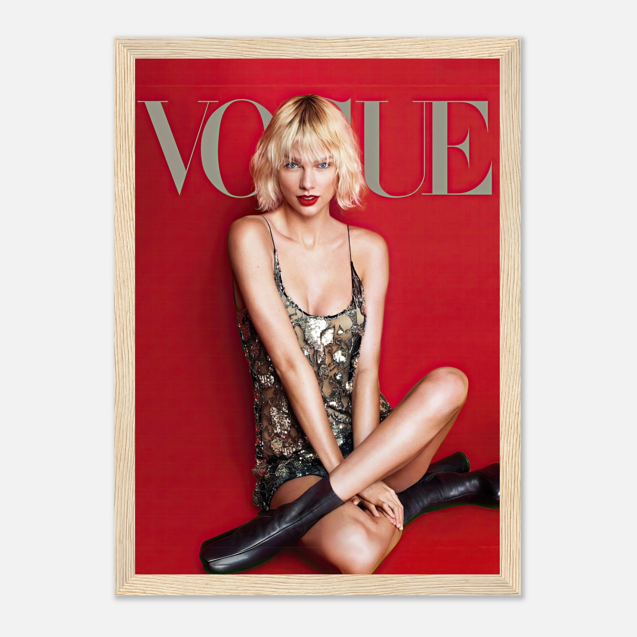 Taylor Swift Vogue framed poster featuring her in a metallic dress against a striking red backdrop.