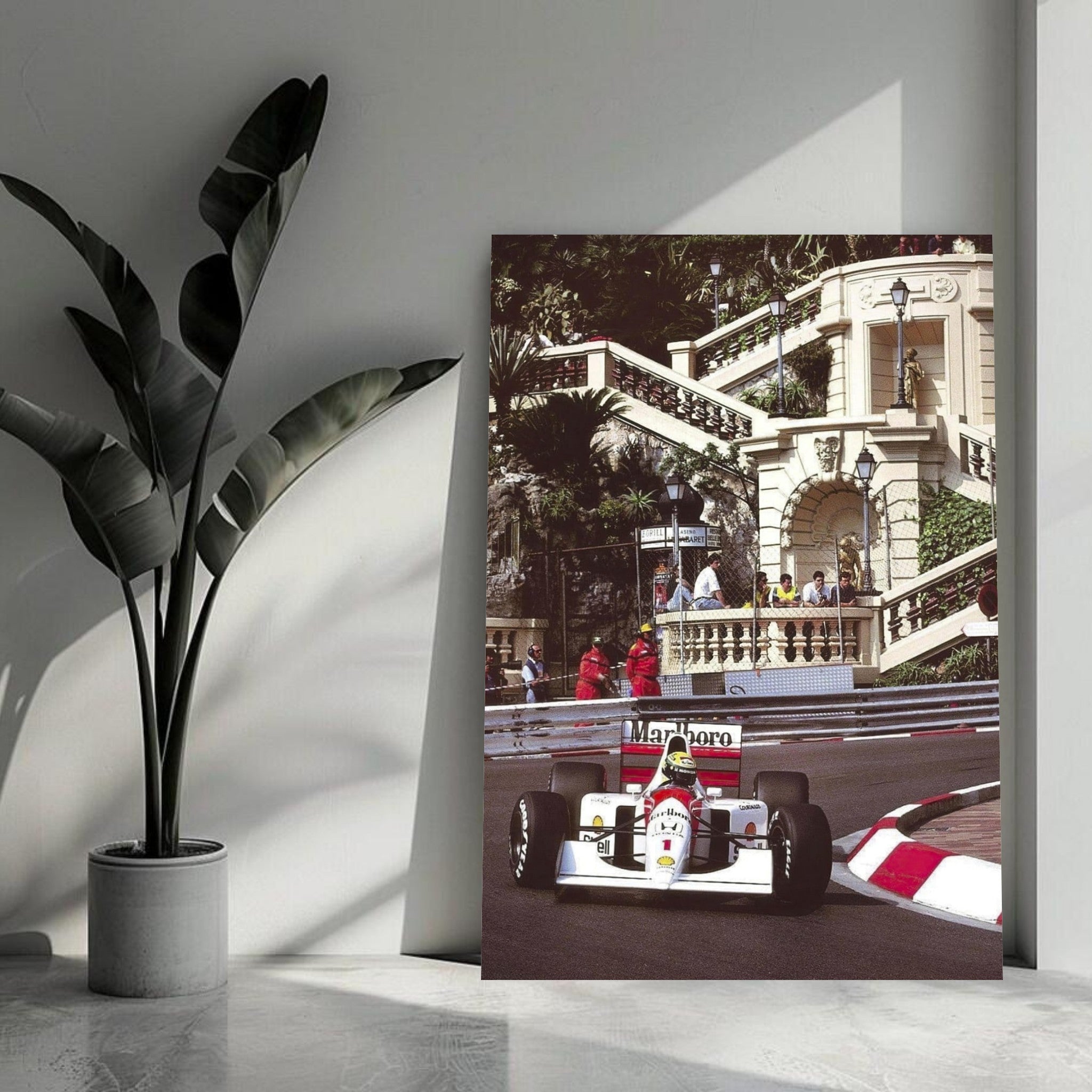 Ayrton Senna racing at Monaco displayed on a metal print, showcasing vibrant colors and sleek design in a modern setting.