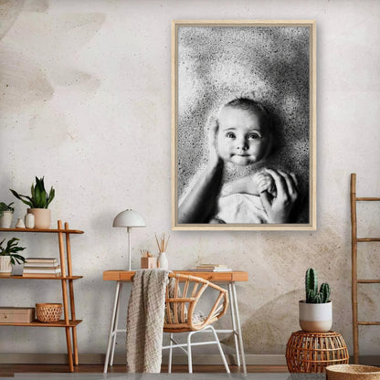 Black-and-white framed canvas print of a joyful baby surrounded by bubbles, adding warmth to any home decor.