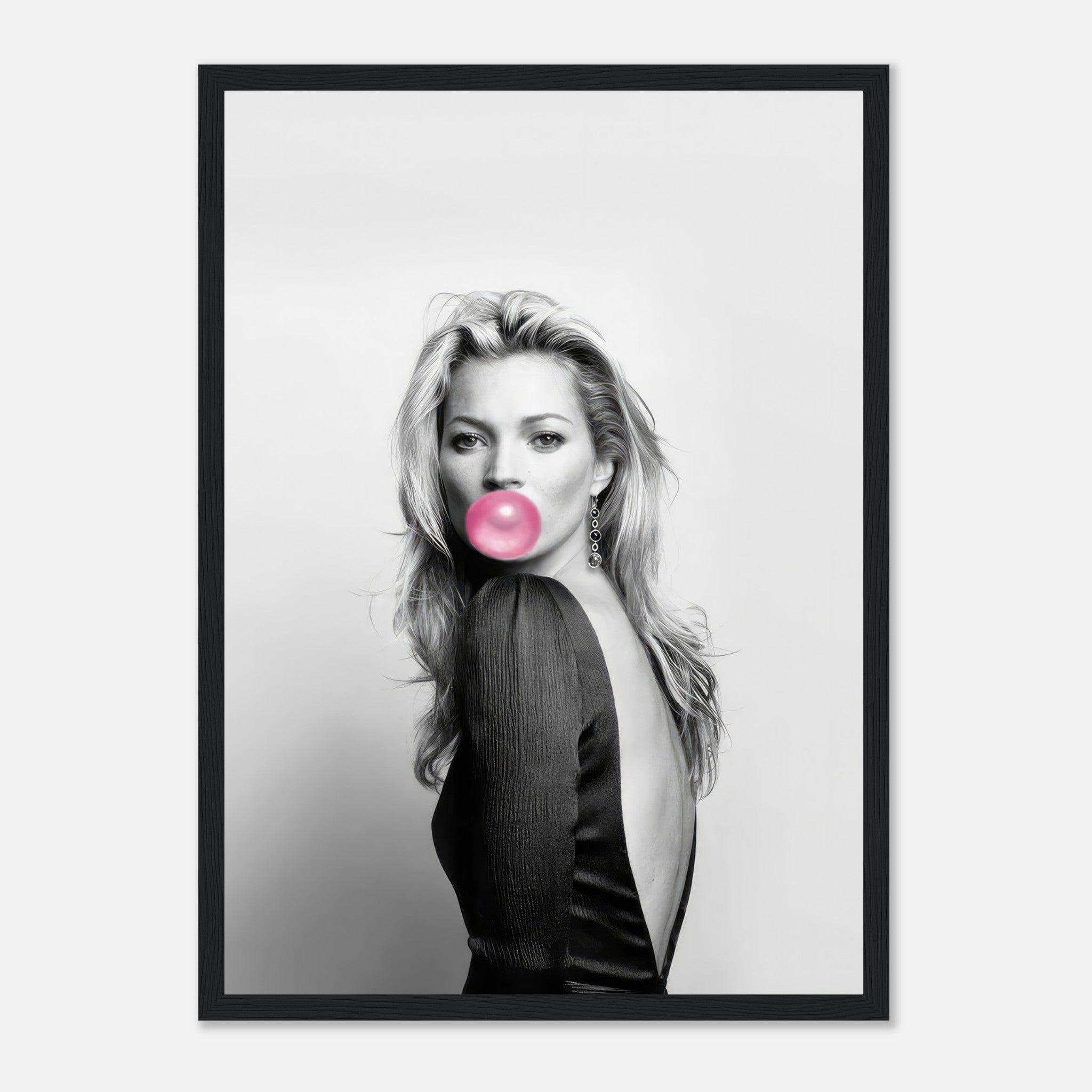 Framed print of Kate Moss in black and white, blowing bubblegum, adding modern elegance to any decor.