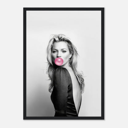 Framed print of Kate Moss in black and white, blowing bubblegum, adding modern elegance to any decor.