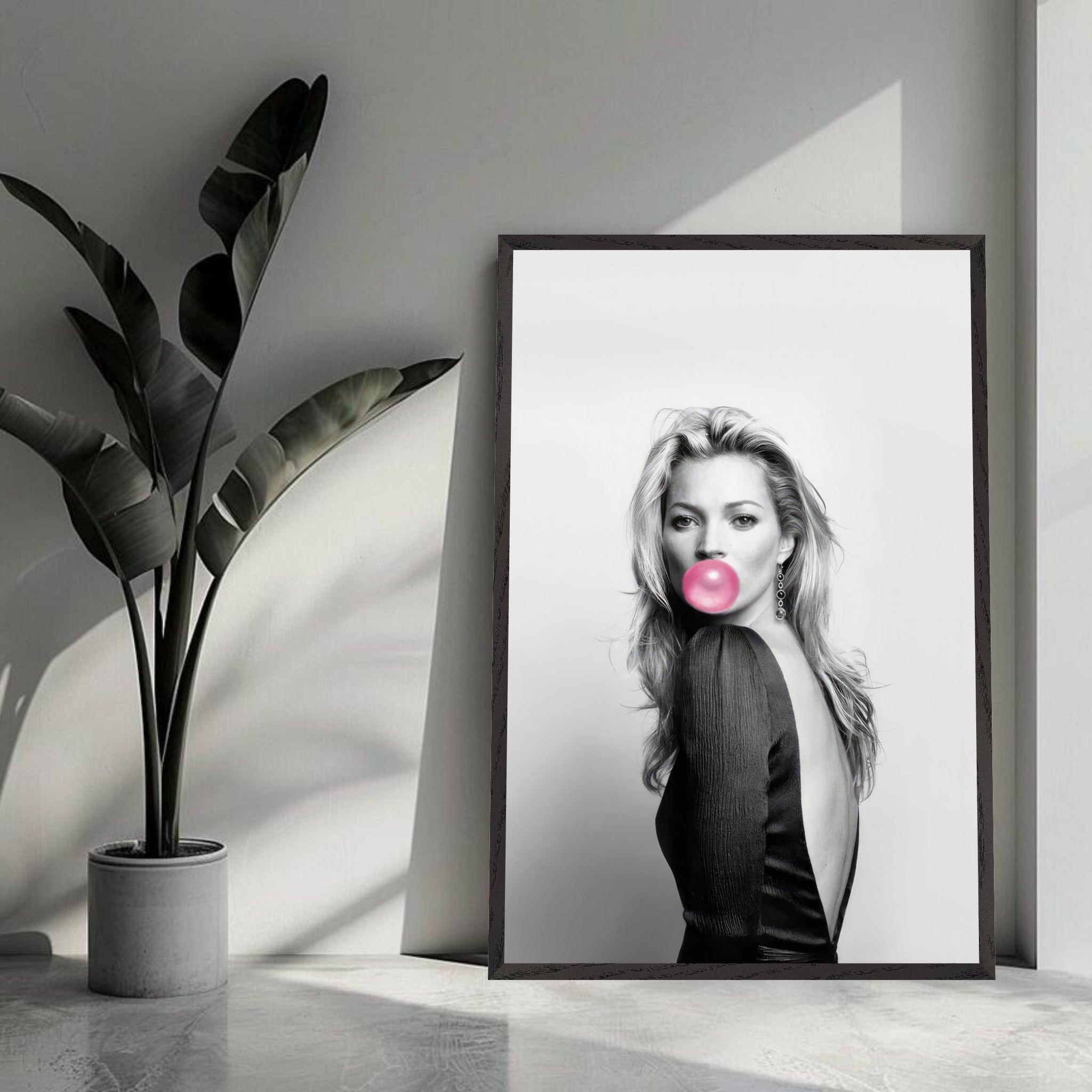 Kate Moss vintage print with pink bubble gum in a sleek black frame, enhancing modern home decor.