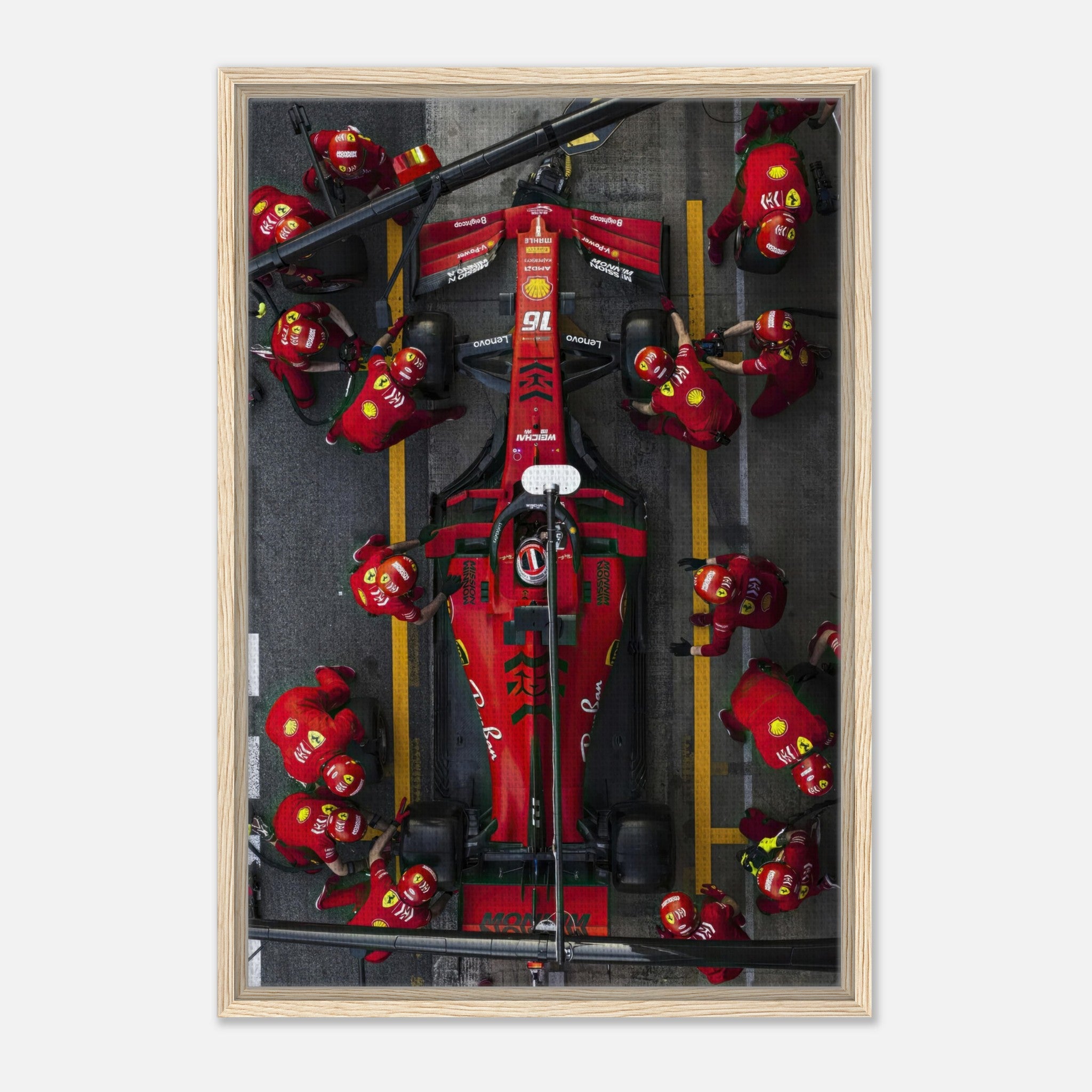 Framed canvas print of a Ferrari Formula 1 pitstop, showcasing vibrant colors and dynamic motorsport action.