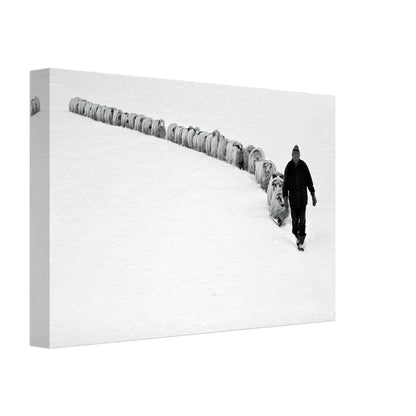 Shepherd guiding his flock through a serene snow-covered landscape in a striking black-and-white canvas print.