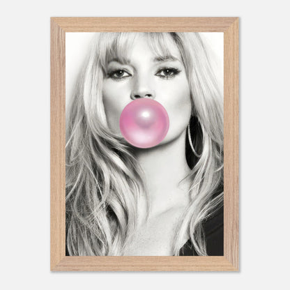 Vintage framed print of Kate Moss blowing pink bubble gum, blending black-and-white portrait with playful color.