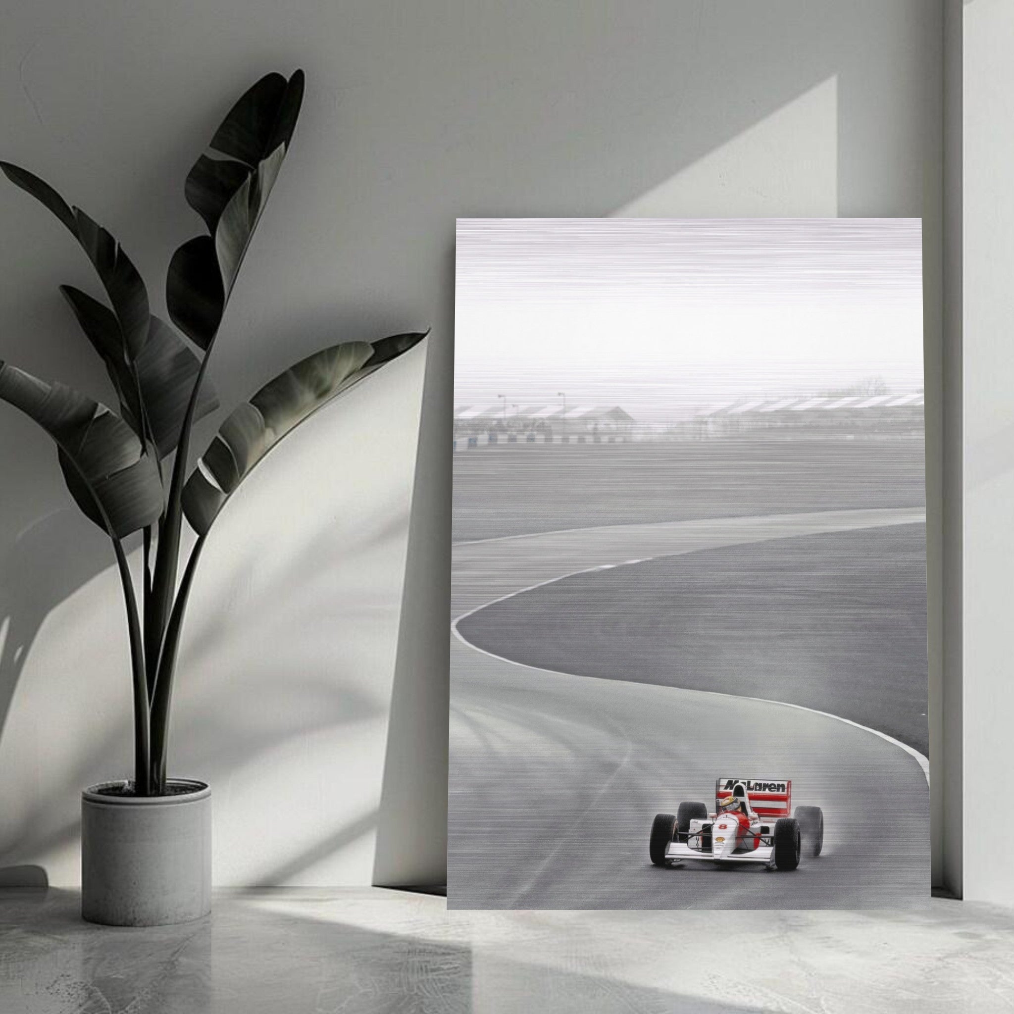 Ayrton Senna McLaren racing photograph on brushed metal, showcasing F1 legend in action on a sleek track.