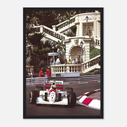 Ayrton Senna racing at Monaco Grand Prix, framed print showcasing vibrant colors and iconic moments in motorsport history.