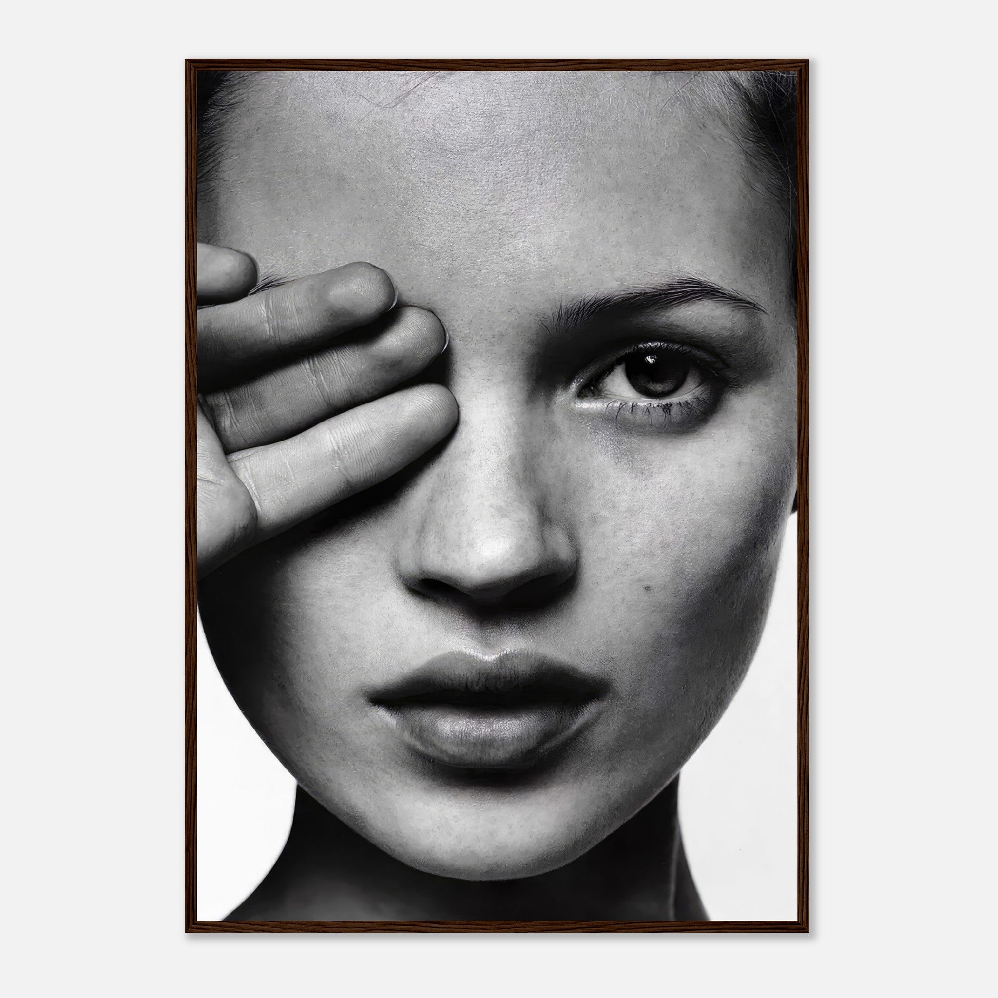 Black and white portrait of a woman's face with one eye covered, framed art print highlighting elegance and modern style.