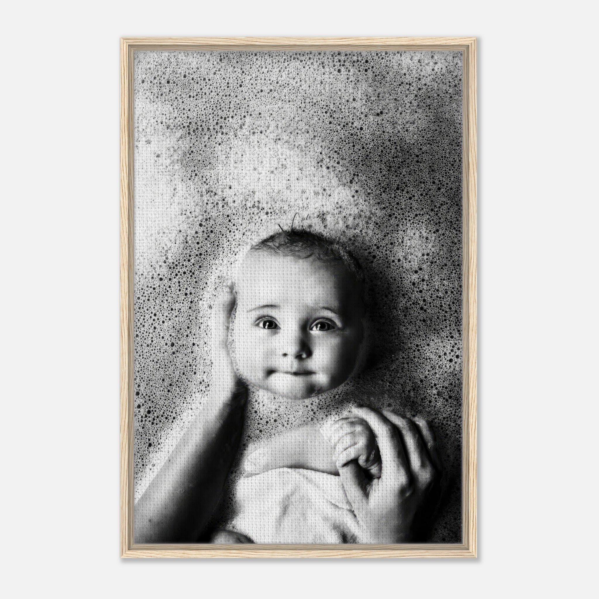 Framed canvas print of a serene baby smiling in bubbles, showcasing innocence and joy during bath time.