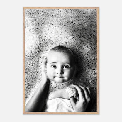 Vintage framed print of a serene baby in bubbles, capturing childhood innocence in black and white photography.