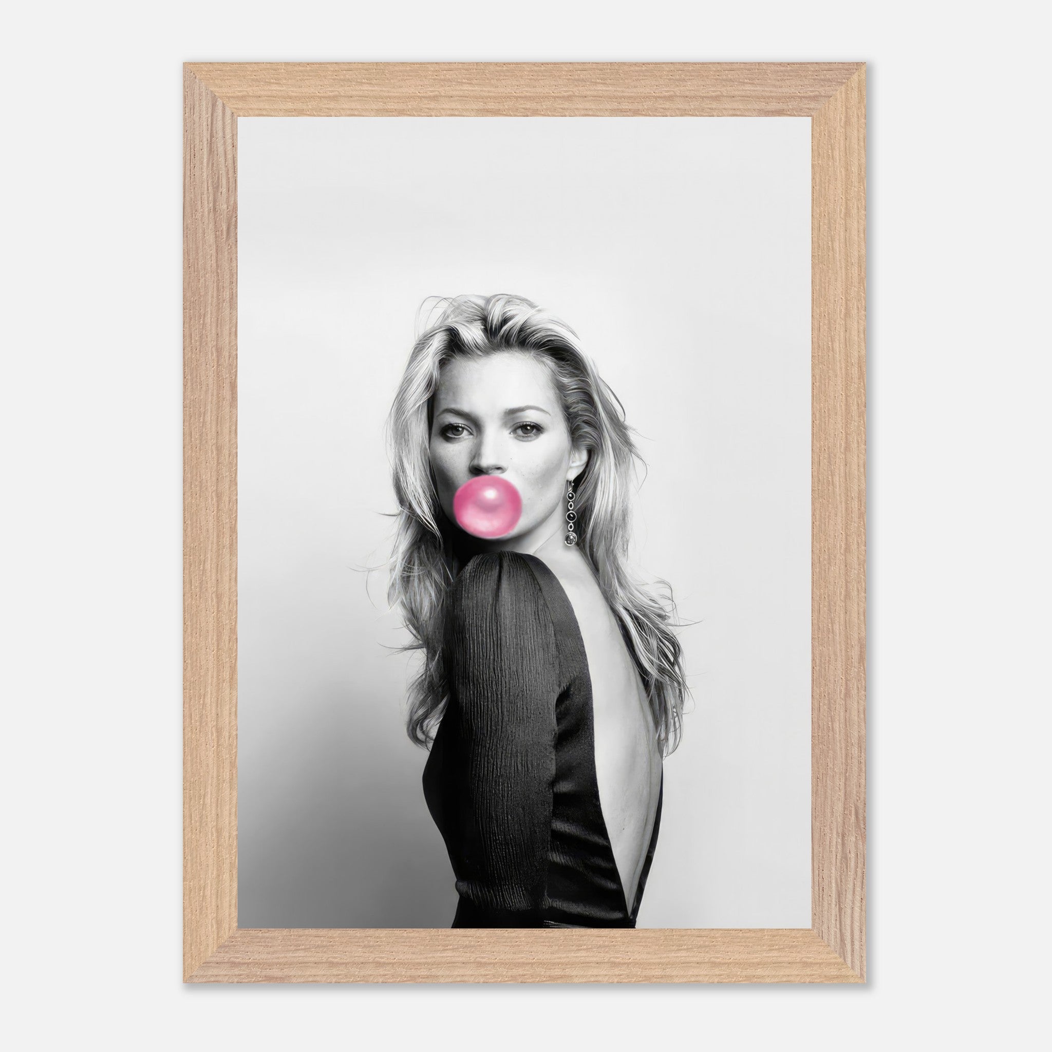 Vintage framed print of Kate Moss blowing pink bubble gum in a stylish black-and-white portrait.