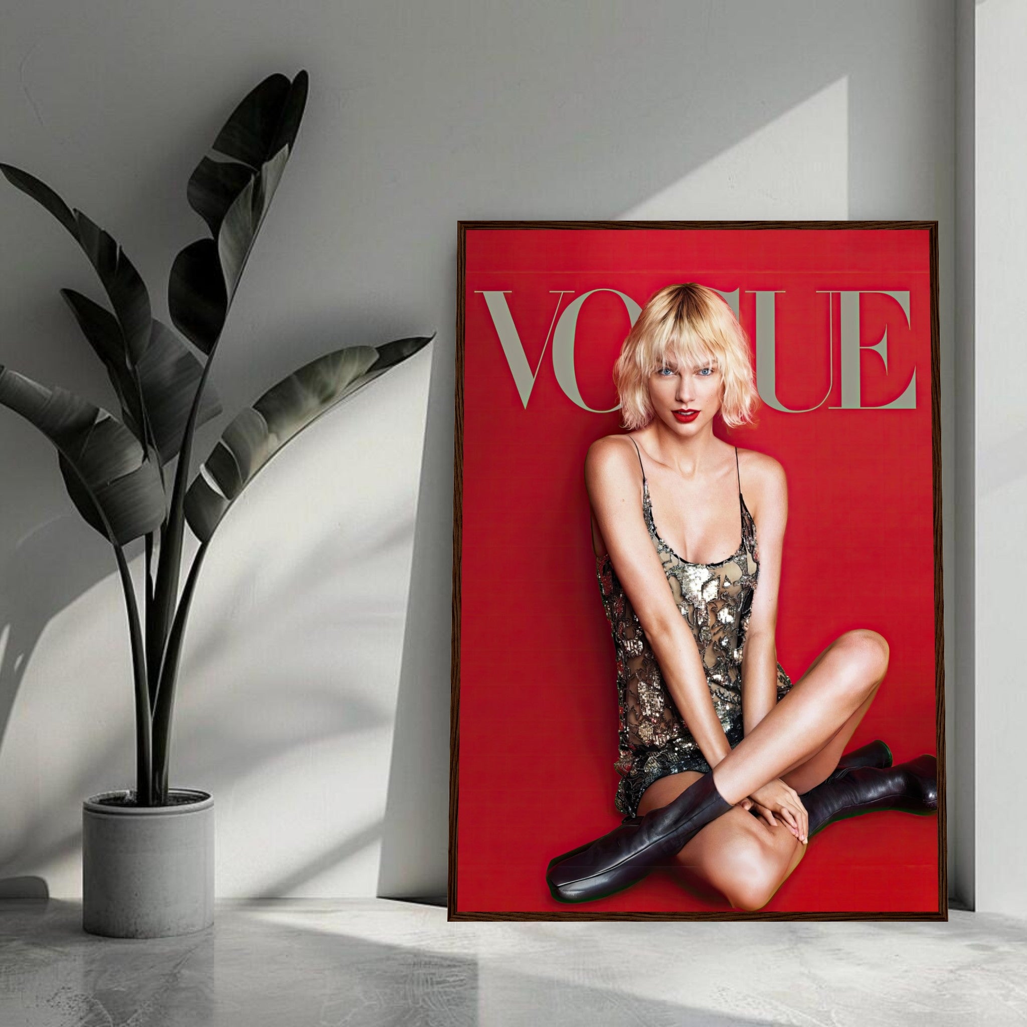 Taylor Swift Vogue framed poster featuring a stunning image with a red backdrop and metallic sequined dress, showcasing elegance.