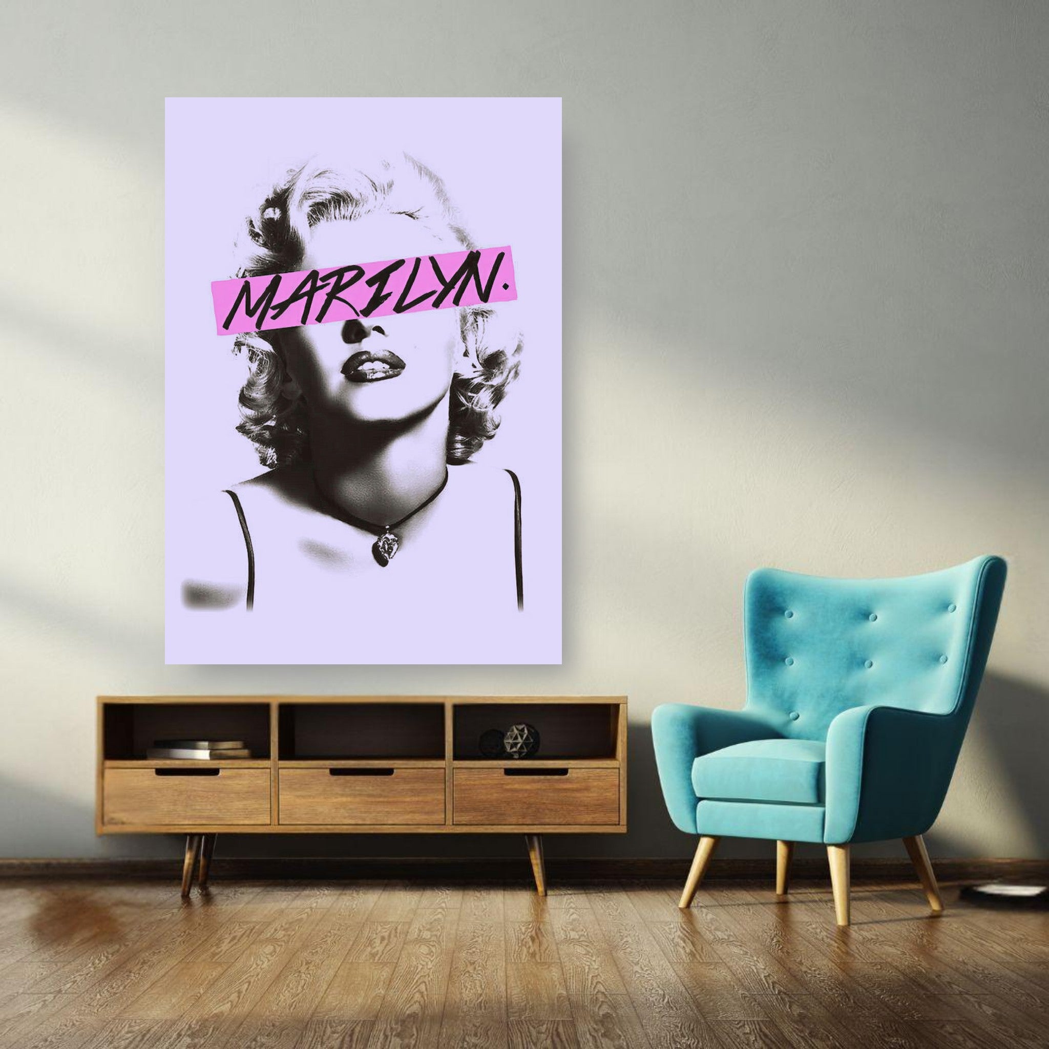 Marilyn Monroe black-and-white poster with vibrant pink overlay in modern living room setting.