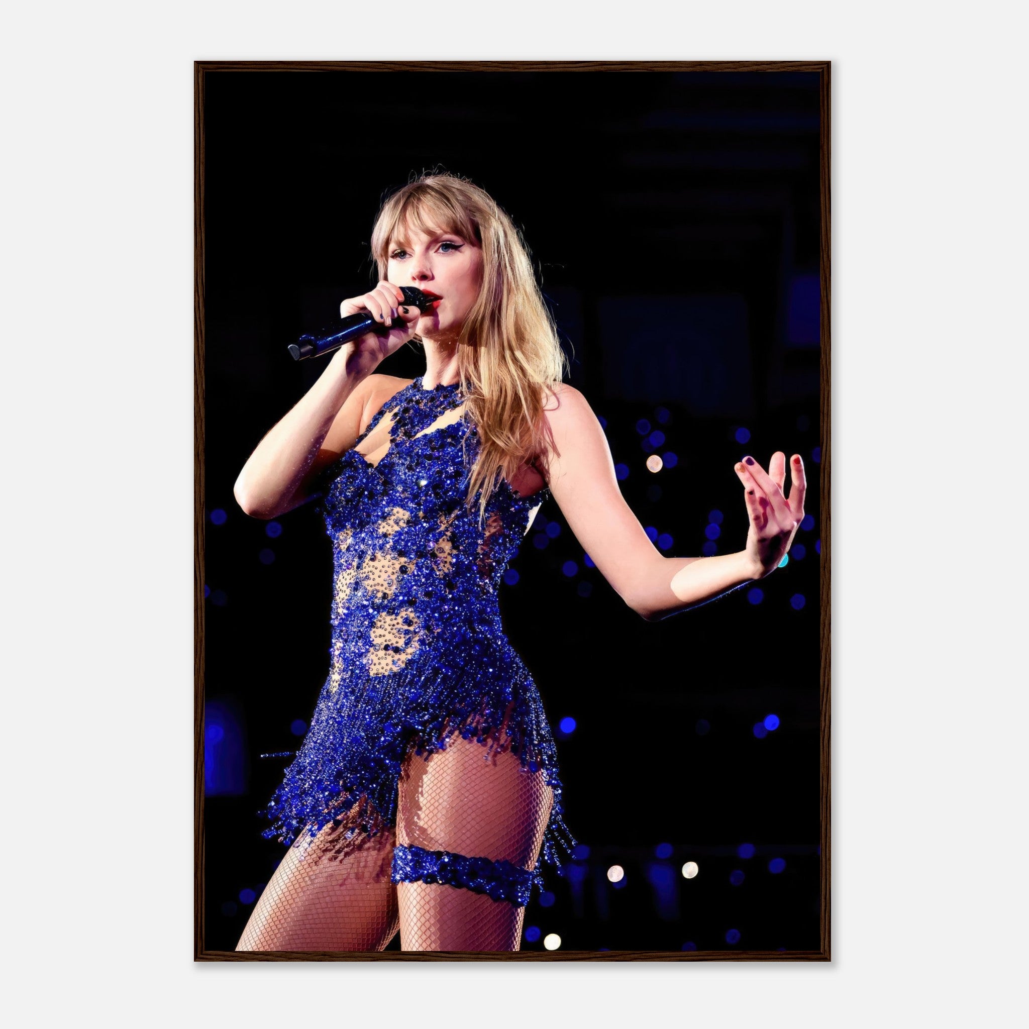 Taylor Swift performance photo in dazzling blue outfit, framed print capturing her vibrant stage energy.