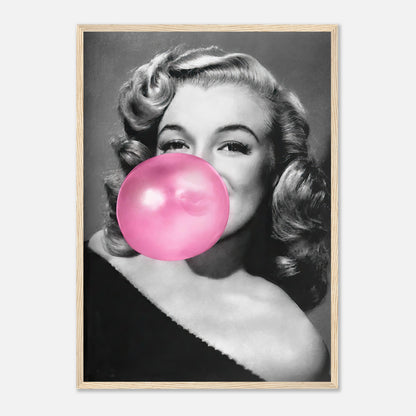 Marilyn Monroe blowing a pink bubble gum, framed print adding glamour and sass to home décor.