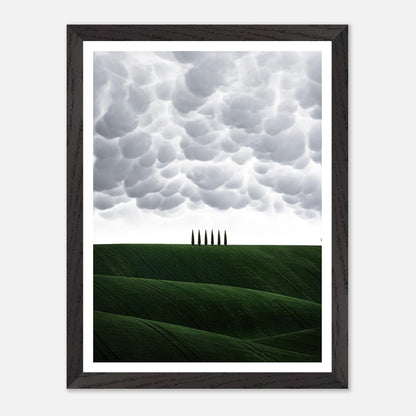 Toscana vintage framed art featuring lush green hills and cypress trees under a dramatic cloudy sky.