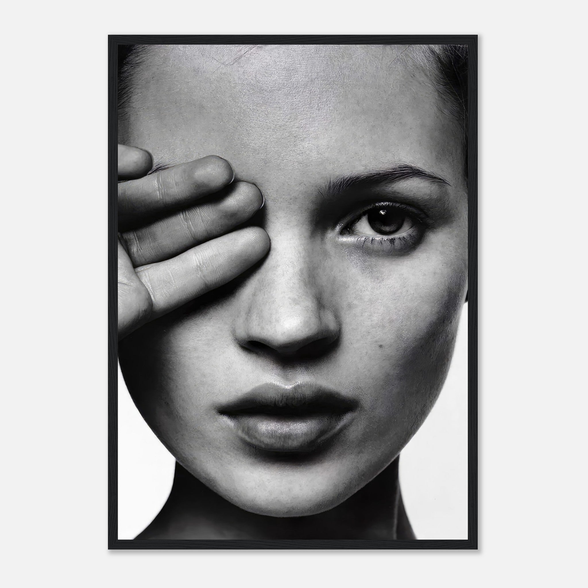 Kate Moss black and white photography framed print featuring a striking portrait with a hand partially covering her face.