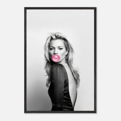 Vintage framed print of Kate Moss with pink bubble gum, blending classic fashion photography and modern style.