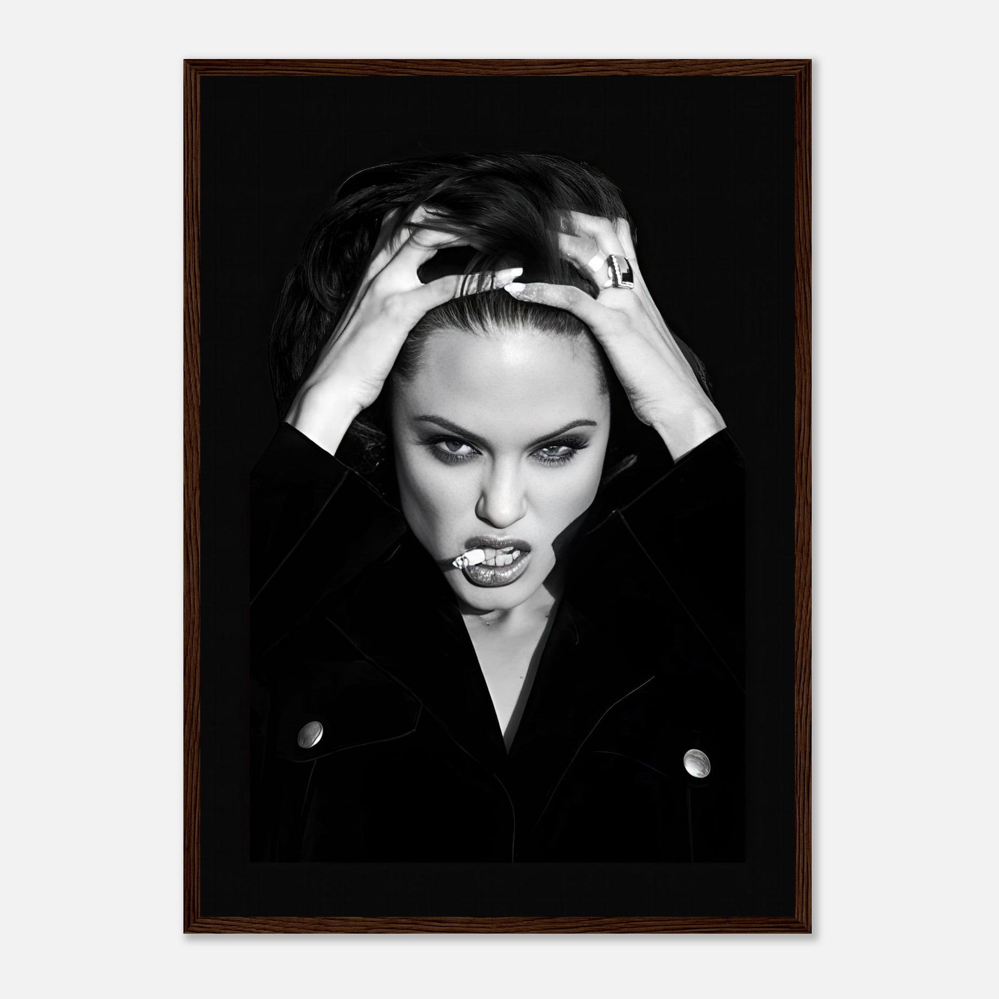 Framed black-and-white print of a fierce woman with striking features and an edgy expression.