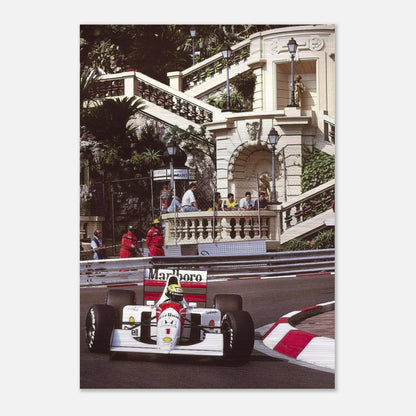 Ayrton Senna racing at Monaco, captured in a brushed metal print with vibrant colors and dynamic scenery.