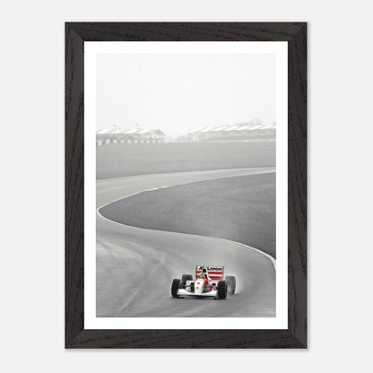 Vintage framed art of 1988 Ayrton Senna racing the McLaren MP4/4 on a winding track.