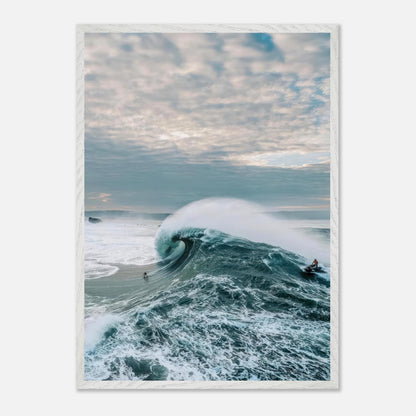 A thrilling moment of big wave surfing with a surfer riding a colossal wave against a dramatic sky.