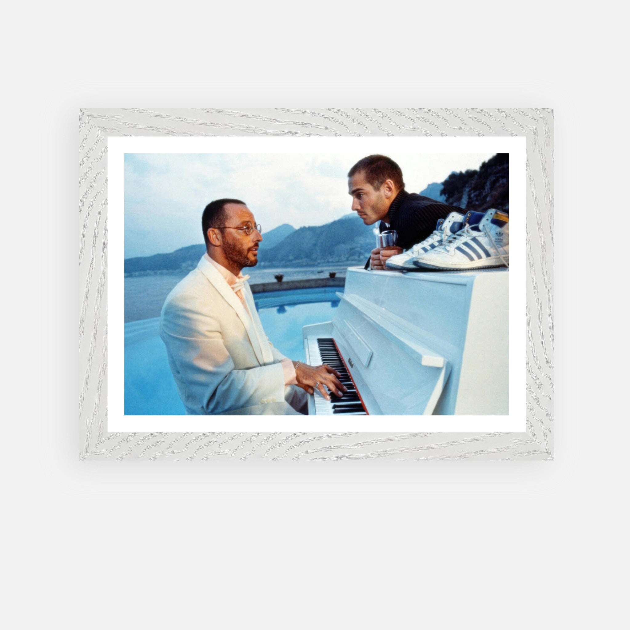 Jean Reno at the piano with a serene seaside view, vintage framed print from "The Big Blue." Classic cinema artwork.