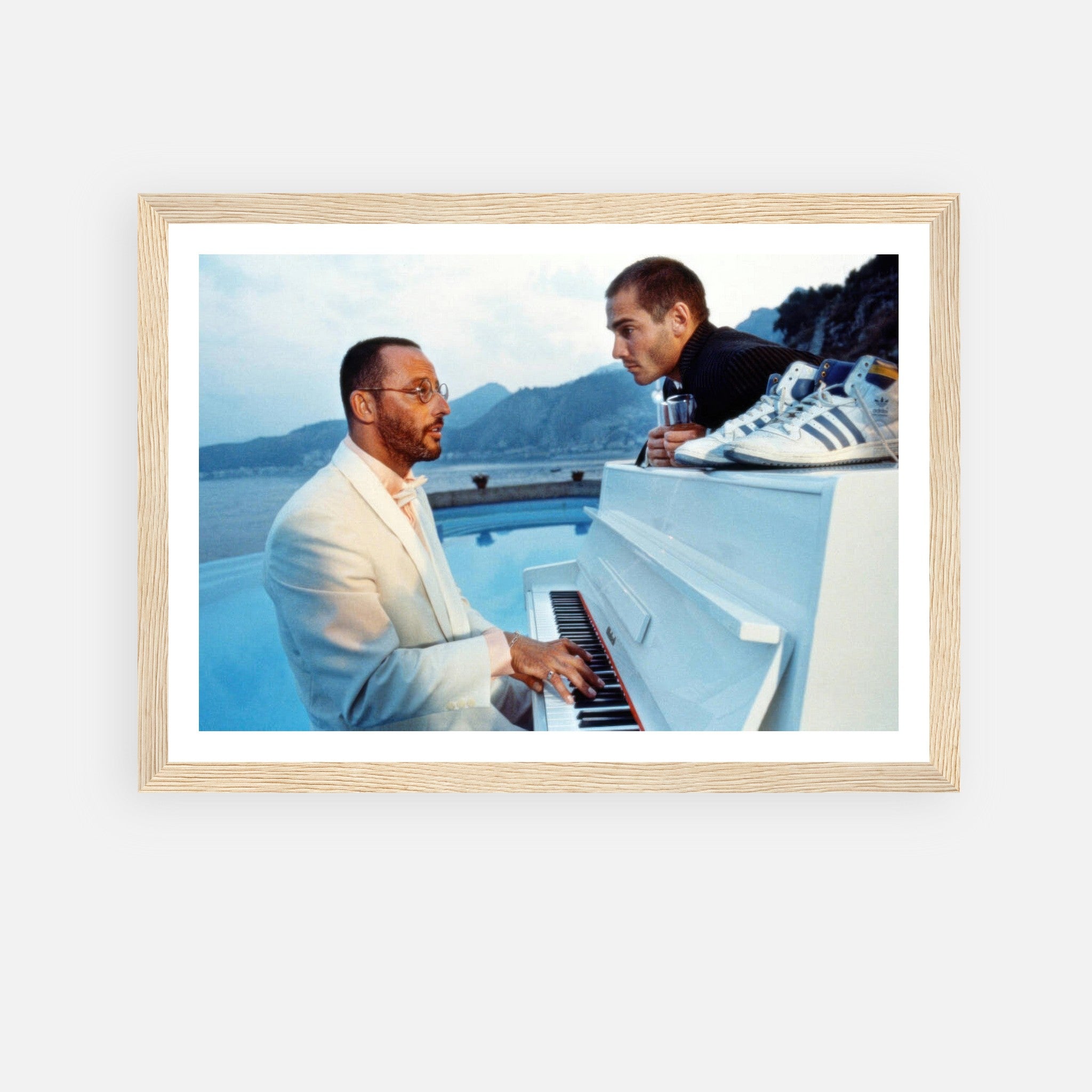 Jean Reno Piano Framed Print showcasing an iconic scene from "The Big Blue" with ocean backdrop and vintage charm.