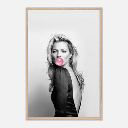 Kate Moss vintage print with pink bubble gum, framed in a stylish wood frame, adding elegance to home decor.