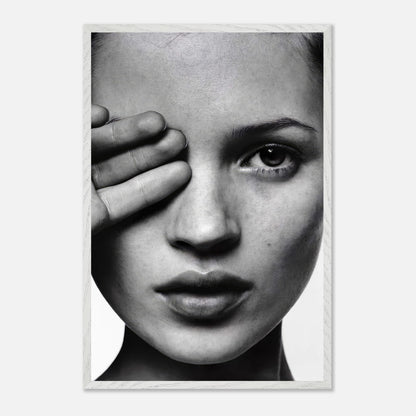 Black and white photograph of a woman covering one eye, framed vintage print by Kate Moss, exuding elegance and sophistication.