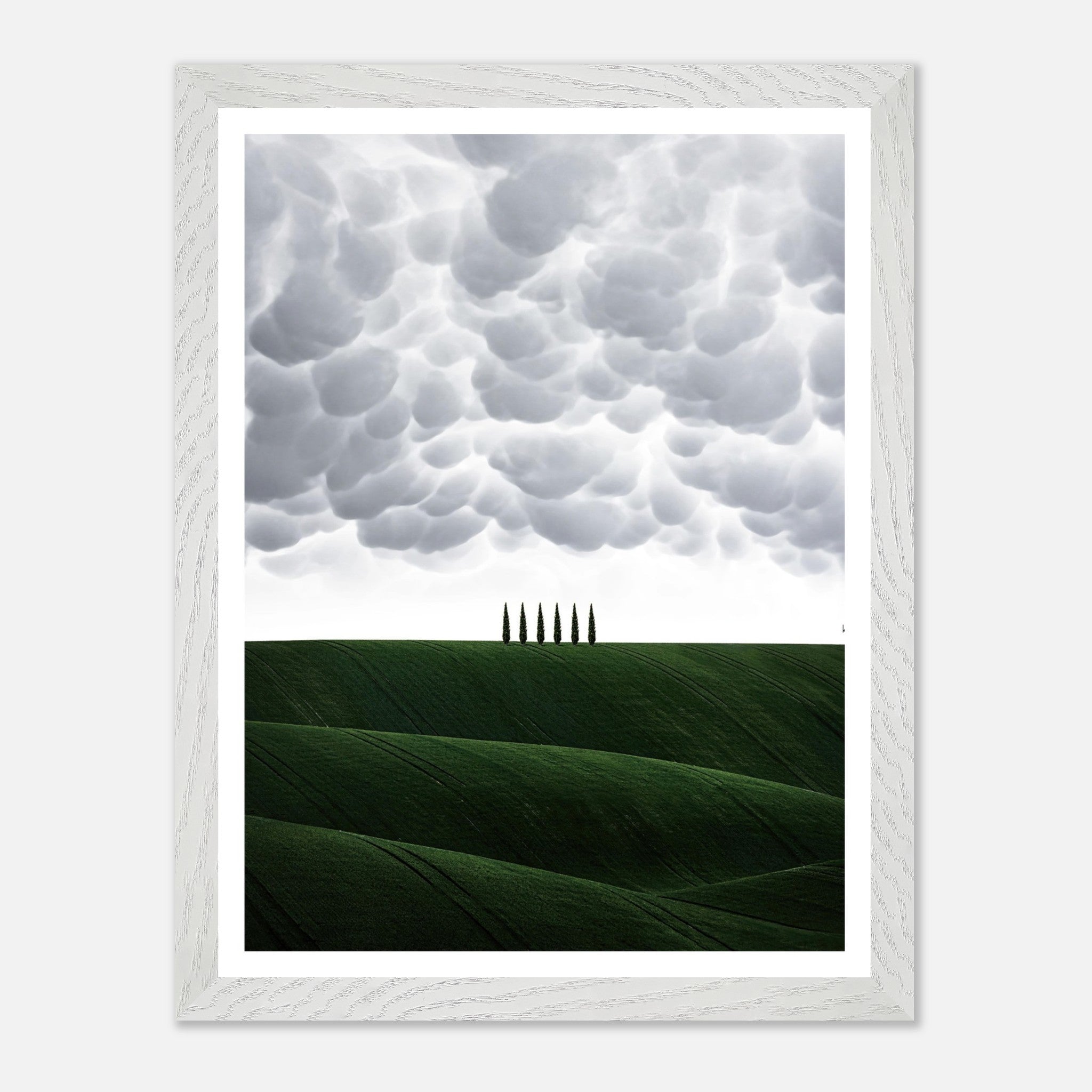 Toscana vintage framed art featuring rolling green hills and cypress trees under a dramatic cloudy sky.