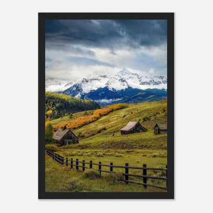 Framed print of Telluride, Colorado showcasing snow-capped mountains and rustic barns in a vibrant landscape.