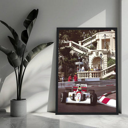 Framed print of Ayrton Senna racing at the Monaco Grand Prix, capturing vibrant colors and historic moments.