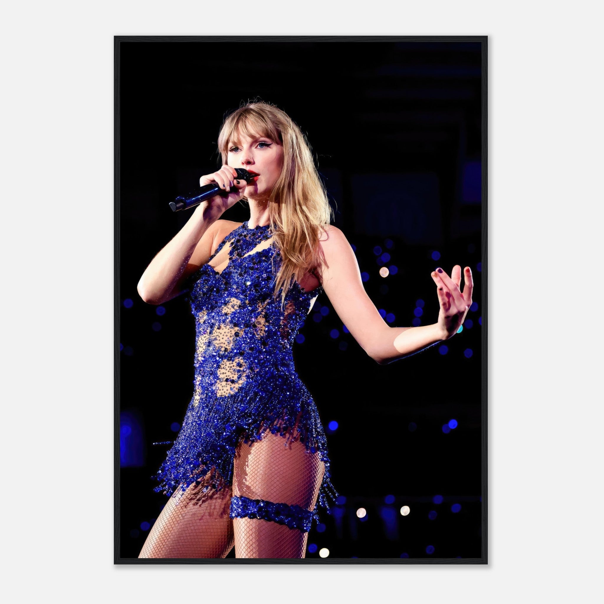 Taylor Swift performing in a dazzling blue outfit, captured in a framed print that showcases her vibrant stage presence.