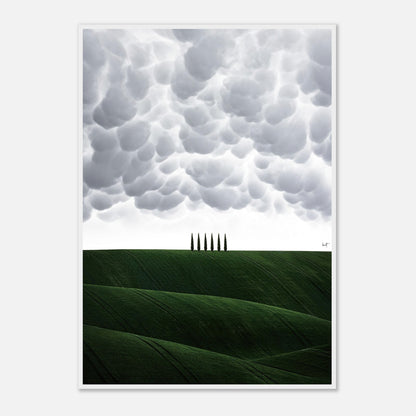 Framed print of Tuscany's rolling hills and cypress trees under dramatic clouds, capturing Italy's serene countryside beauty.