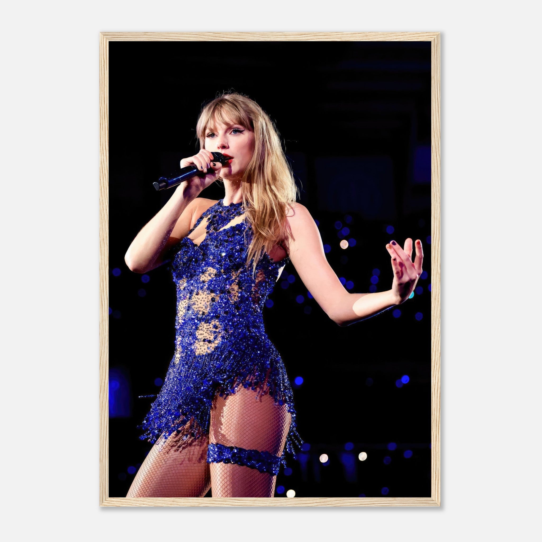 Taylor Swift performing in a dazzling blue outfit, framed print capturing her iconic stage presence.