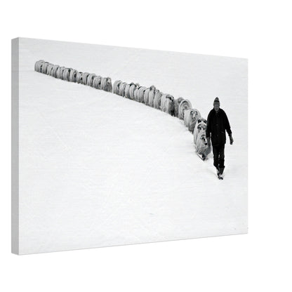 Black-and-white canvas print of a shepherd walking with his flock in a snow-covered landscape.