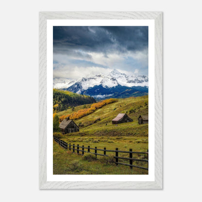 Framed Giclée fine art print depicting Telluride, Colorado with rustic barns and snow-capped mountains.