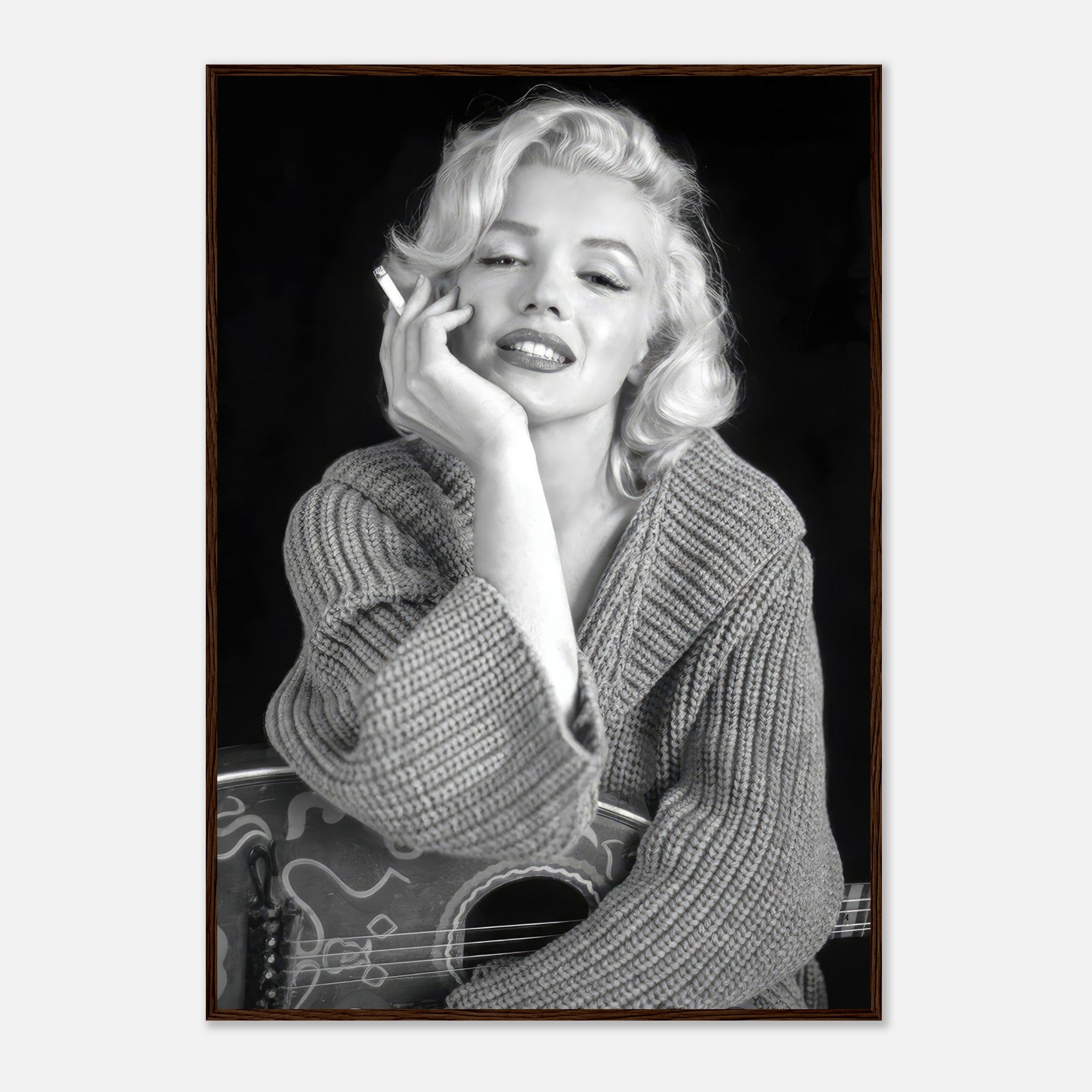 Marilyn Monroe smoking in a cozy knit sweater, exuding elegance in a classic black-and-white framed poster.