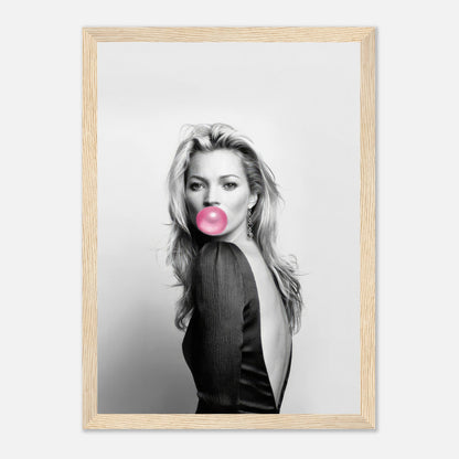 Black-and-white portrait of Kate Moss blowing bubble gum in a stylish framed print, showcasing modern pop art.