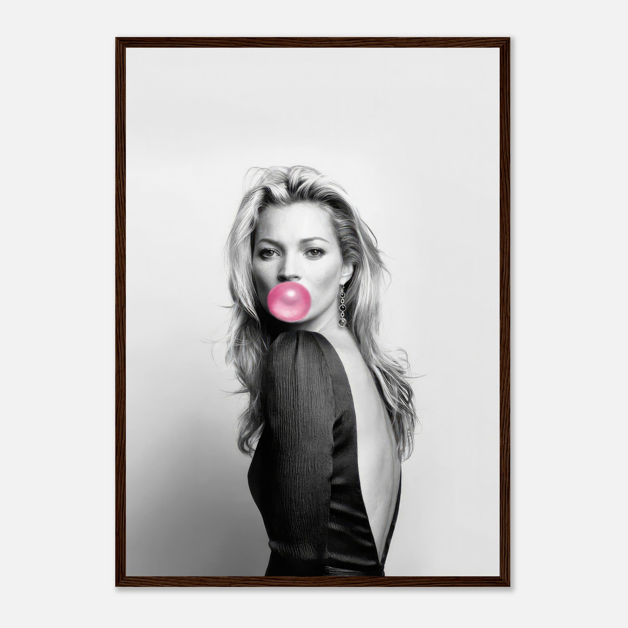 Framed print of Kate Moss blowing bubble gum in a black-and-white portrait with pink accent, stylish wall art.