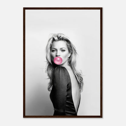 Framed print of Kate Moss blowing bubble gum in a black-and-white portrait with pink accent, stylish wall art.