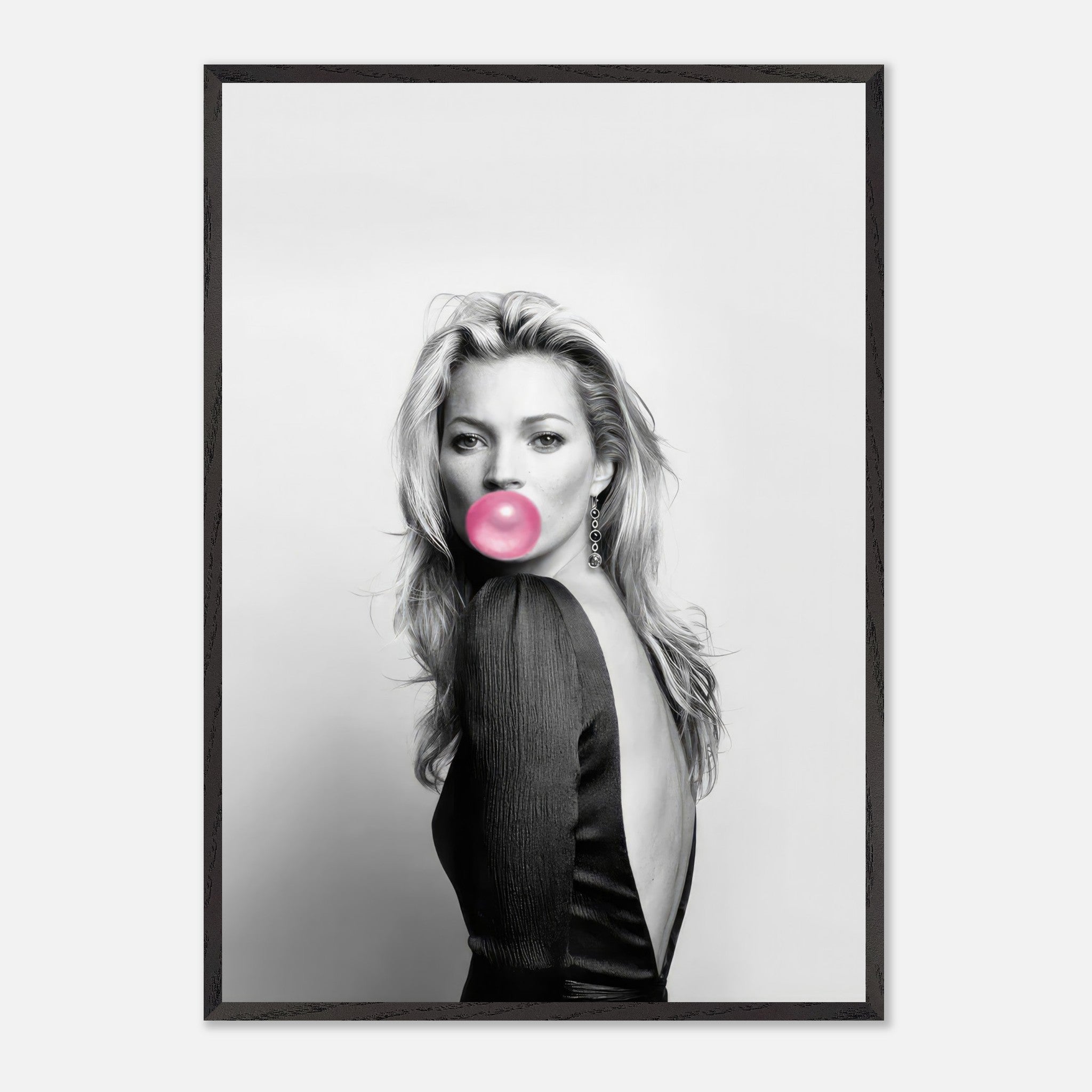 Vintage framed black-and-white portrait of a woman blowing pink bubble gum, showcasing modern fashion photography.