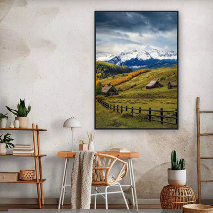 Telluride Colorado framed print showcasing snow-capped peaks and rustic barns in a vibrant green meadow.