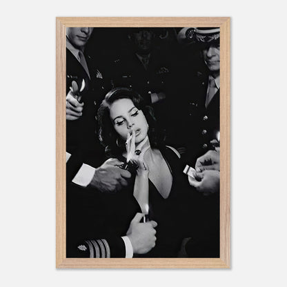 Black and white vintage framed print of a woman smoking surrounded by admirers, exuding timeless elegance and charm.