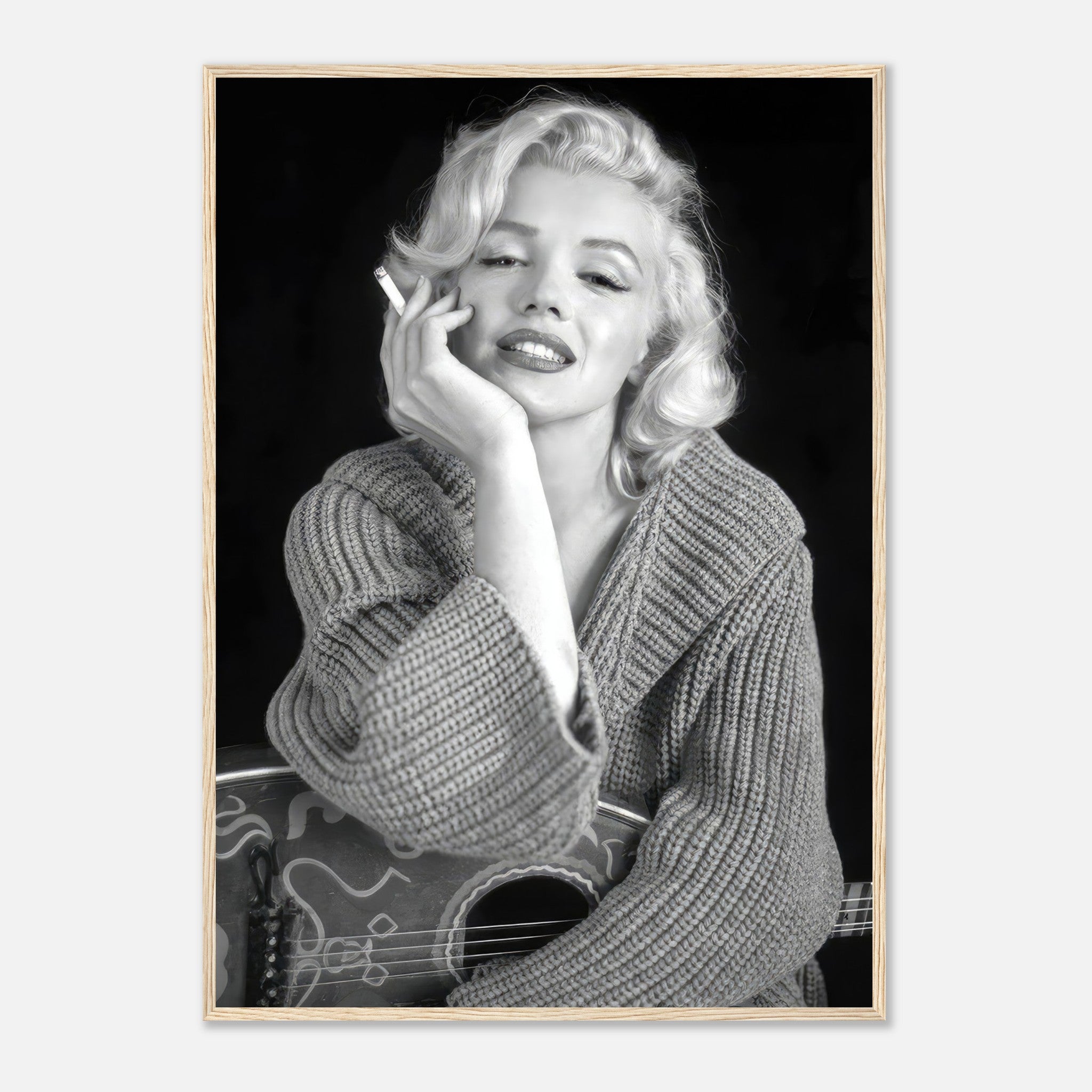 Marilyn Monroe in a cozy sweater, smoking, with a guitar in a black-and-white framed poster, exuding classic Hollywood charm.