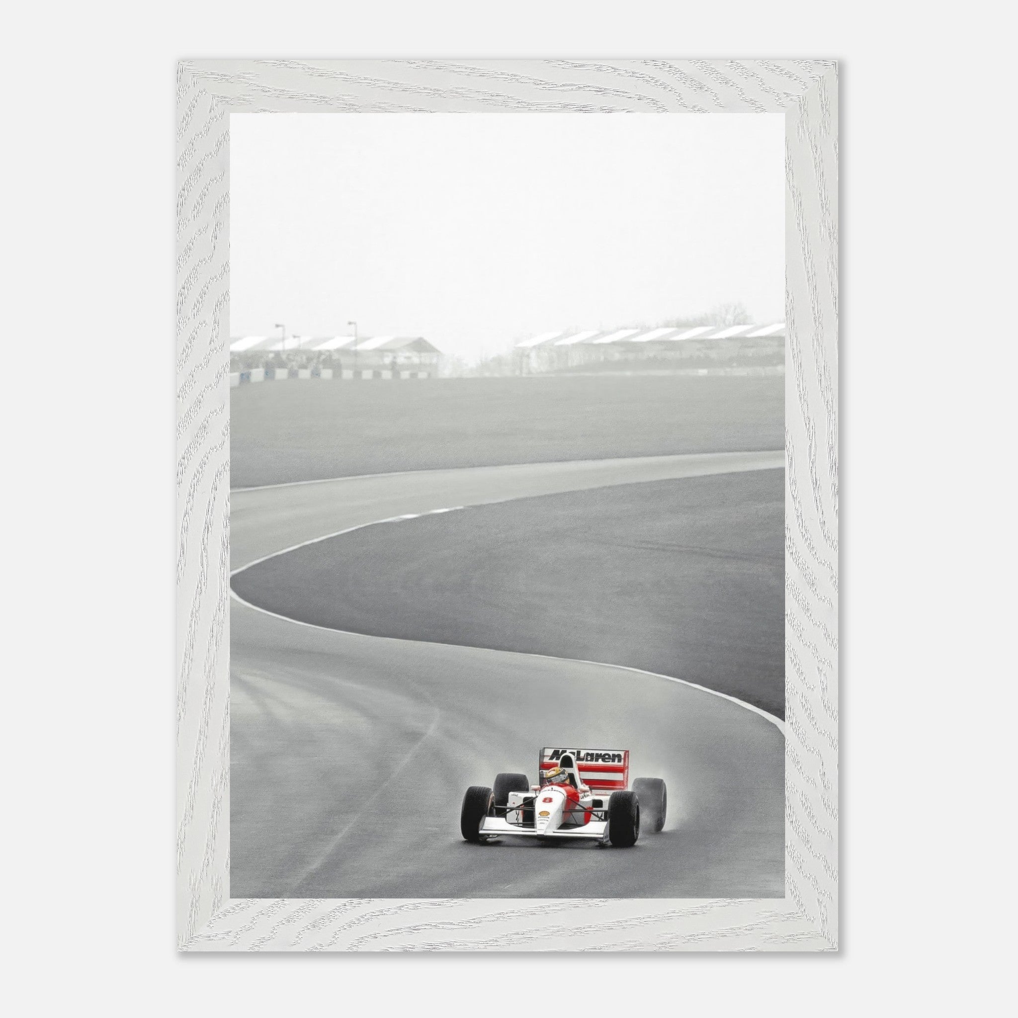 Vintage framed photography of Ayrton Senna driving a McLaren on the racetrack, capturing Formula 1's iconic moment.